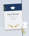 Cap & Laurel navy and gold graduation party invitation, styled flat-lay with envelope