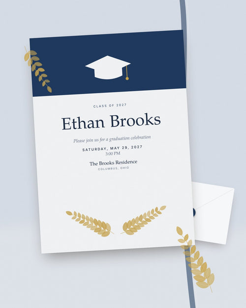 Cap & Laurel navy and gold graduation party invitation, styled flat-lay with envelope