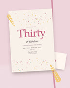 Confetti Hour milestone birthday party invitation, styled flat-lay with envelope