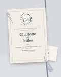 Crest classic monogram wedding invitation, styled flat-lay with envelope