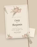 Heirloom vintage parchment floral wedding invitation, styled flat-lay with envelope