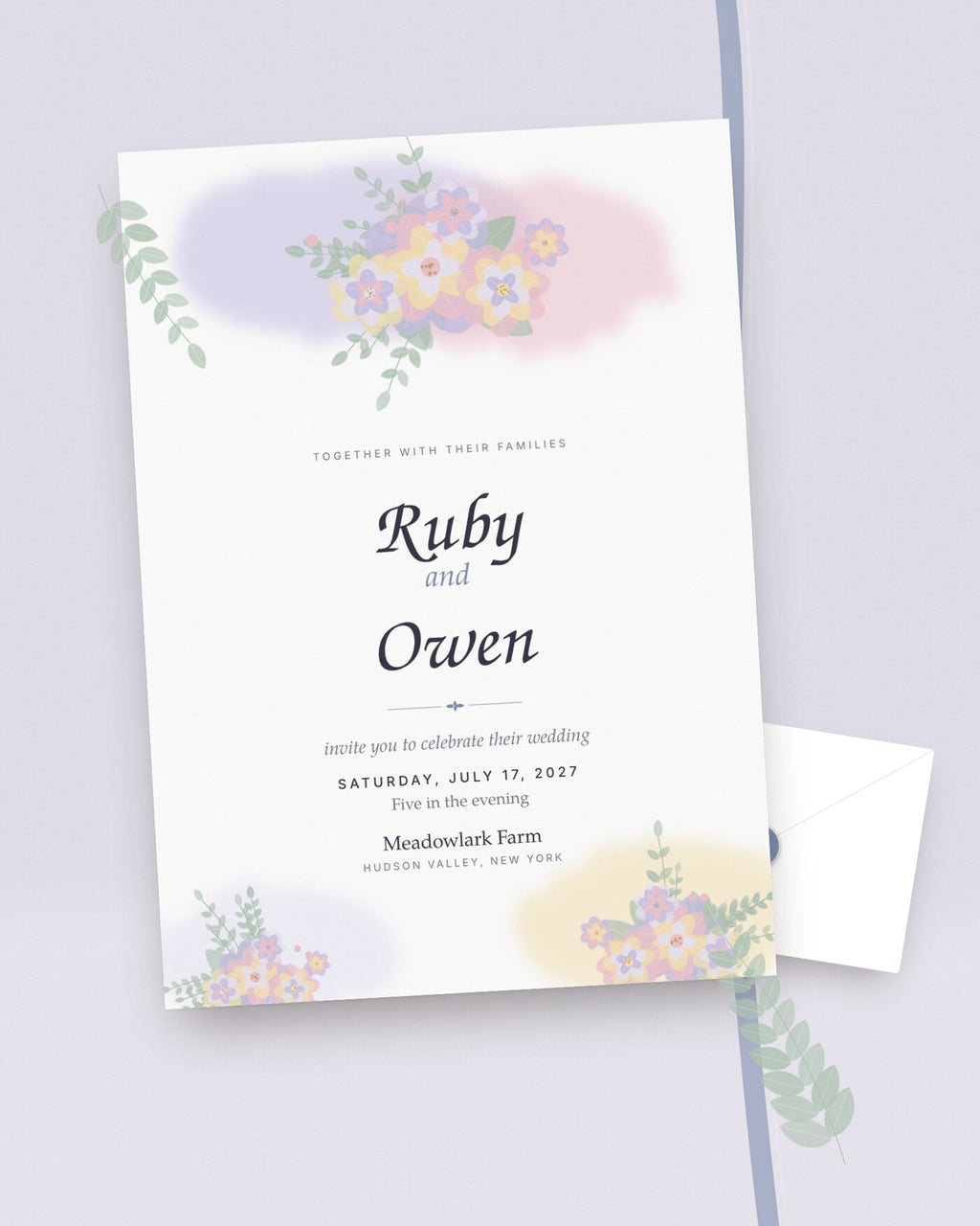 Wildflower Wash watercolor wedding invitation styled flat-lay with lavender and blush blooms