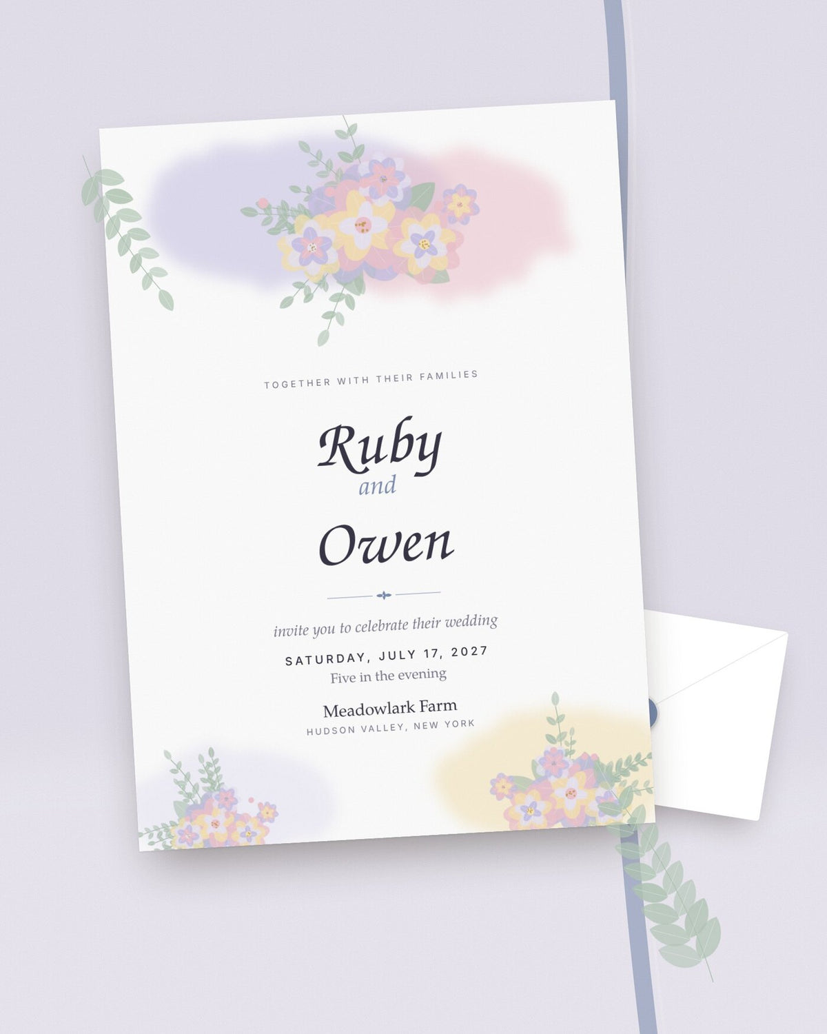 Wildflower Wash watercolor wedding invitation styled flat-lay with lavender and blush blooms